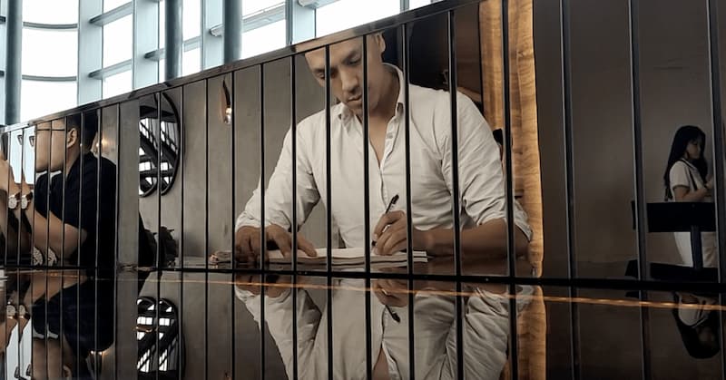 Chou-Tac drawing on his sketchbook at a bar counter (Landmark 81, Vietnam)